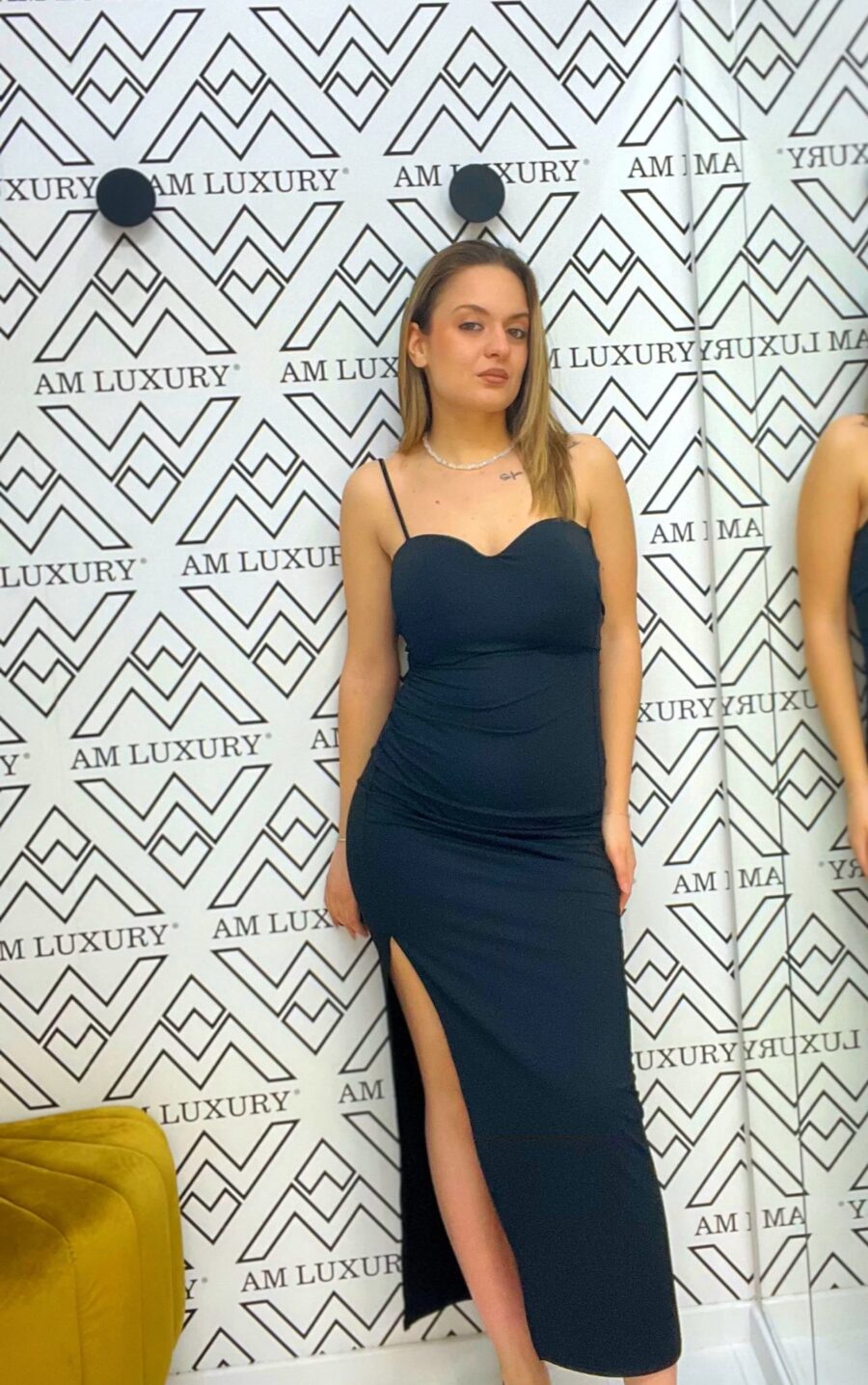 Vestito lungo a bratelle con il dettaglio dello spacco laterale, dona un tocco di audacia, perfetto per un outfit che unisce femminilità e stile.