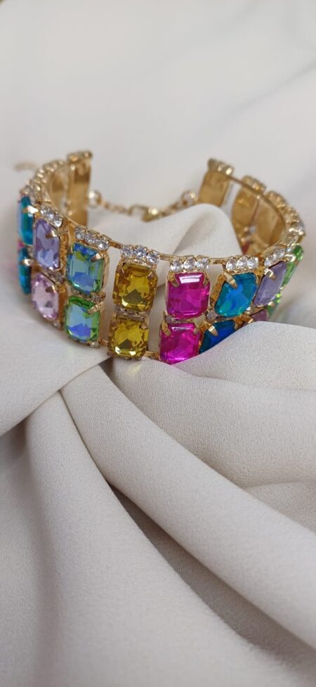 Bracciale rigido color oro, composto da doppia fila di cristalli rettangolari, regolabile.